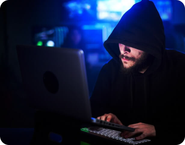 hooded man sneaking into outdated applications in shop floor